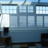 White tier on tier shutters in conservatory 